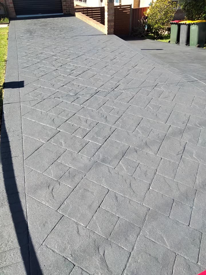 Stone-pattern resurfaced driveway in grey, viewed from the street end