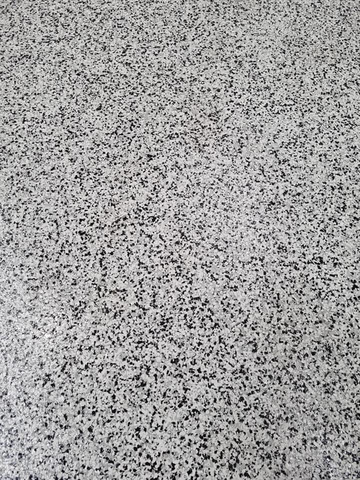 Close-up of a black and white speckled flake floor finish