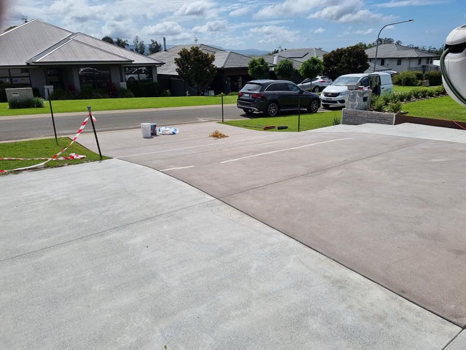 Two-tone resurfaced driveway at a new home, viewed from the garage
