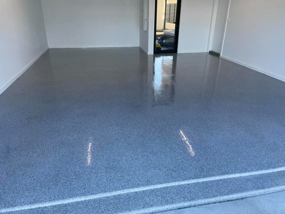 Glossy blue-grey flake floor coating in a garage