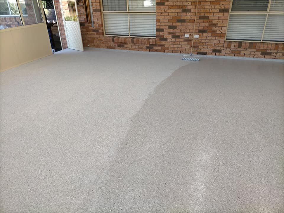 Sunroom floor partly coated, with the wet coating on one side