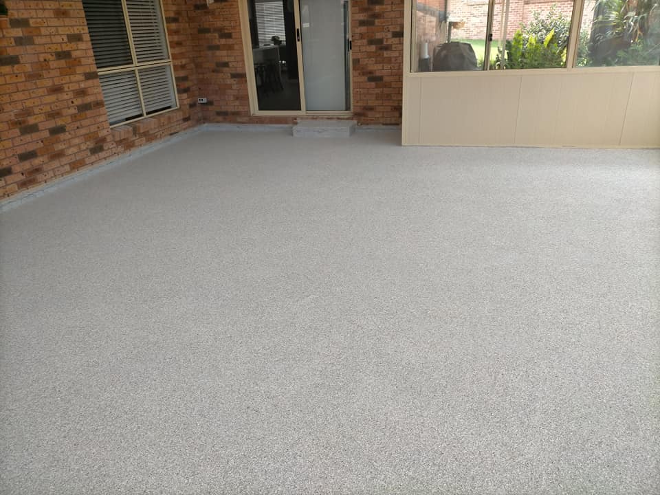 Finished speckled floor in a brick-walled sunroom