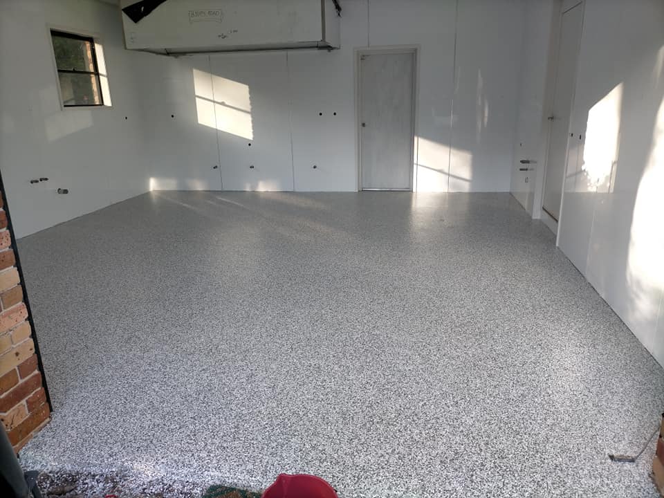 Speckled flake floor coating in a room with white walls