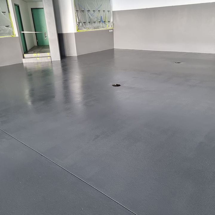 Glossy charcoal floor coating in a large empty commercial space