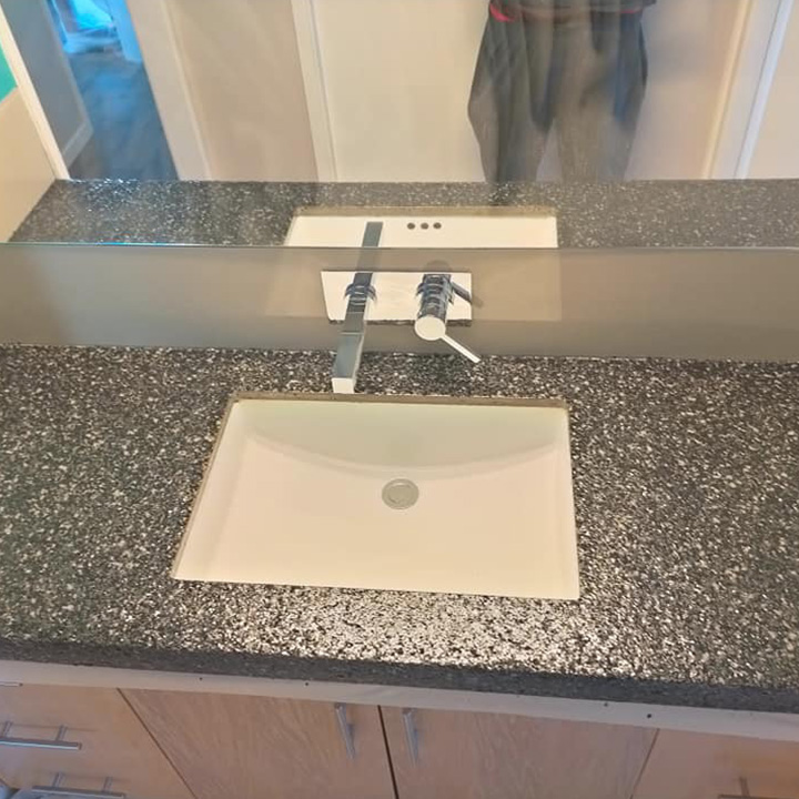 Bathroom vanity with a speckled charcoal benchtop and white basin