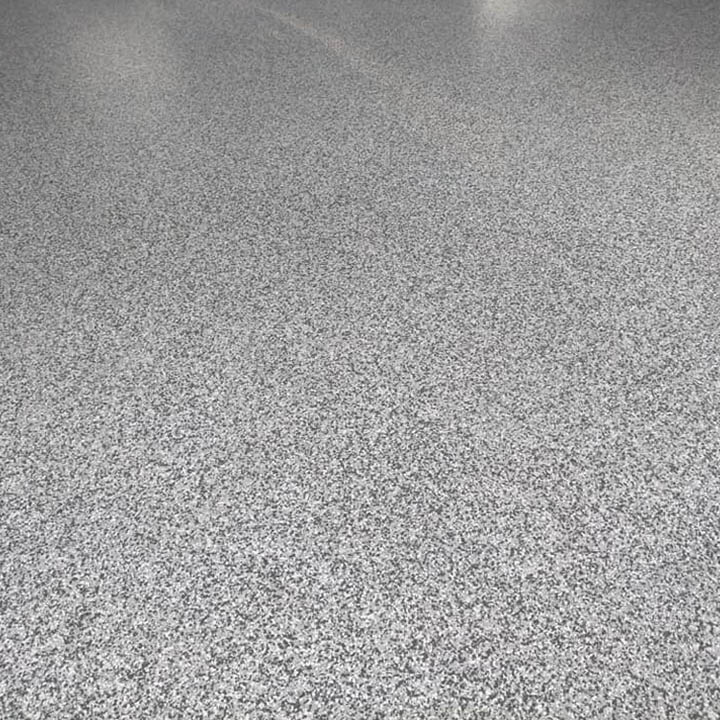 Close-up of a grey speckled flake floor finish