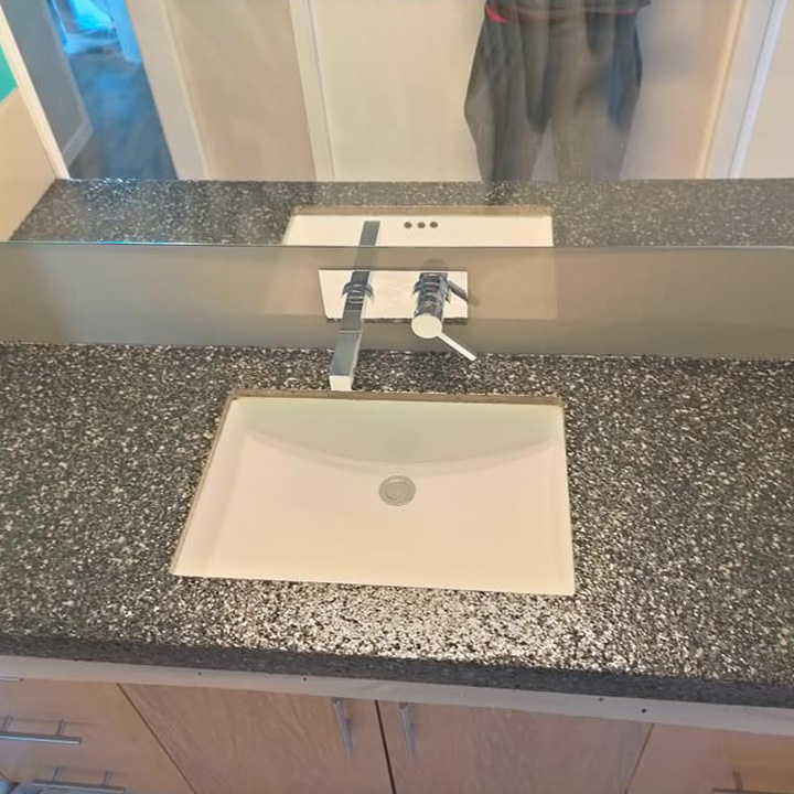 Bathroom vanity with a speckled charcoal benchtop and undermount basin